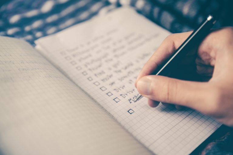 hand written checklist in notebook